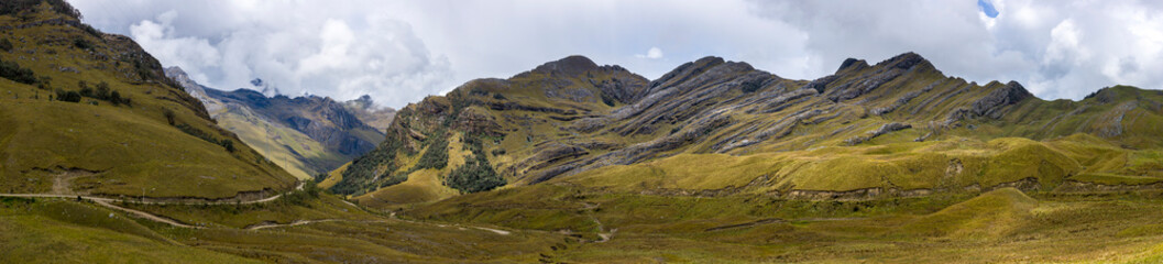 Panoramic view of an Andean landscape with sediment rocks and cloudscape in the background in Ancash Region, Peru