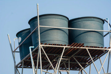 Water tanks on steel bar of rural village.