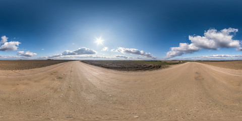 full seamless spherical hdri panorama 360 degrees angle view on gravel road among fields in early...