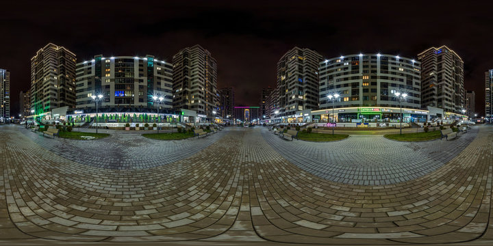 MINSK, BELARUS -  JANUARY 2020: full seamless spherical hdri night panorama 360 near arch between multistory buildings of residential quarter with neon light in windows in equirectangular projection