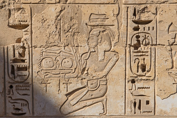 Hieroglyphic carvings on an ancient egyptian temple wall