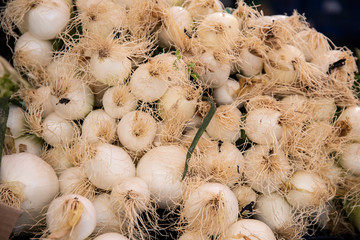 Freshly collected onions from agriculture for kitchen use in a street market for sale to the consumer public that comes to purchase