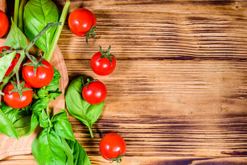 Heap of small cherry tomatoes on wooden table. Top view