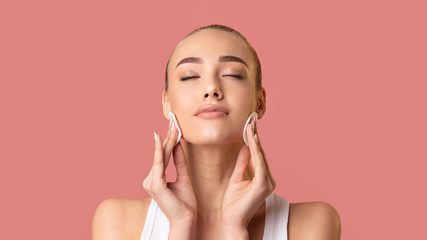 Lady Cleansing Face Skin With Cotton Pads, Pink Background, Panorama