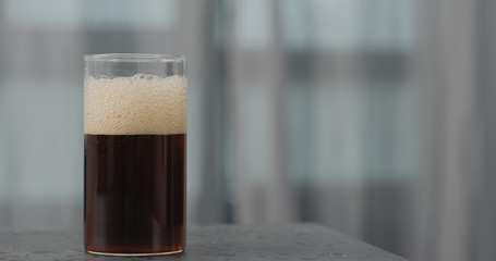 cola in glass on concrete surface