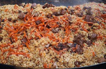 Fragrant delicious pilaf. Street festive freshly prepared food. Delicious rice. Meat and rice. Healthy food.