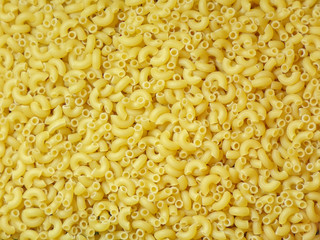 Pasta noodles. Macaroni background top view. Dry pasta for cooking. Abstract macaroni background for design.