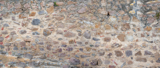 old stone wall with natural rocks and concrete,