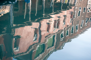 Buildings reflected on the water of one of the Murano canal