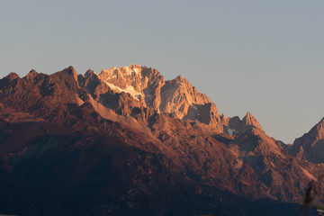 Close up of snow mountain in the early morning time, sunrise, with bright blue sky and copy space