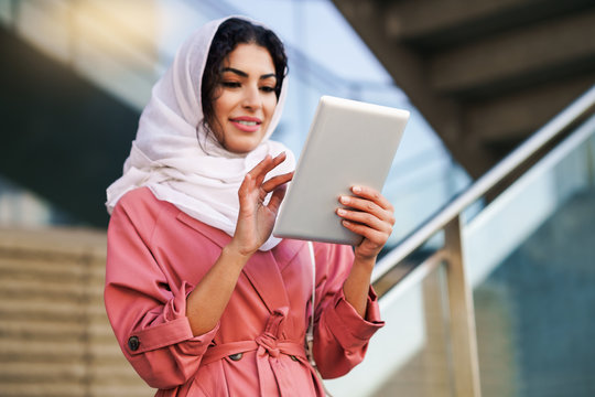 Young Arab Woman Wearing Hijab Using Digital Tablet Outdoors