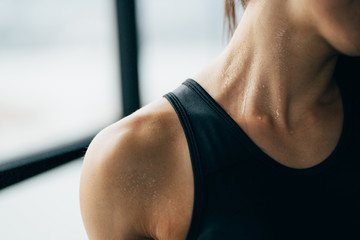 Sweaty muscular body of sporty woman, close up
