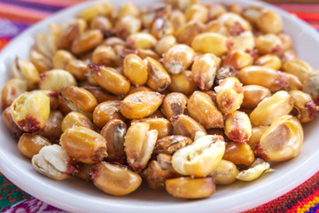 Toasted Andean corn with salt served on a white bowl
