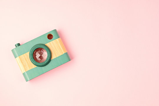 Flat lay with toy wooden camera and hearts. Social media, posts, likes, followers, online photography classes concept. Top view