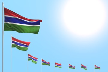 wonderful memorial day flag 3d illustration. - many Gambia flags placed diagonal on blue sky with place for your content