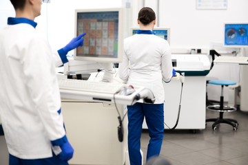 Research scientists working with modern equipment in laboratory