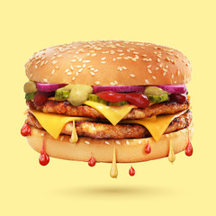 Double cheeseburger on yellow background.