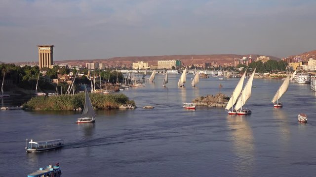 Beautiful landscape with felucca boats on Nile river in Aswan at sunset, Egypt, 4k