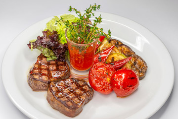  This is a steak and grilled vegetables.