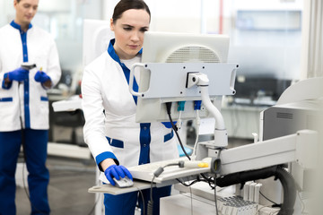 Fototapeta na wymiar Research scientist in lab coat using modern equipment