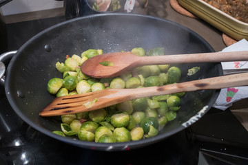 Brussel sprouts cooking in a wok on an electric hob for Christmas dinner