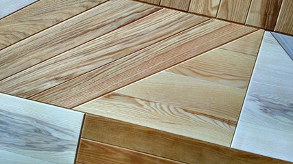 Mixed floor wooden planks placed diagonally. Various woodworking samples background