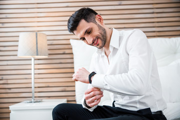 Smiling businessman dressing at home stock photo