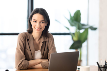 Young manager smiling at camera in modern office