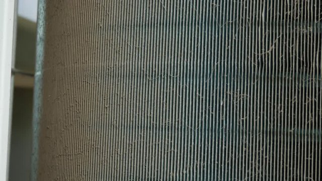 Air conditioning heat sink is dirty with dust. Scene is camera panning