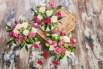 Top view Gift Floristics. Handmade bouquet of roses with herbs in a large mug. Close up. Great gift for Mothers Day, March 8 or Valentines Day