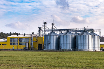 Fototapeta na wymiar Granary elevator. agro-processing and manufacturing plant for processing and silver silos for drying cleaning and storage of agricultural products, flour, cereals and grain.