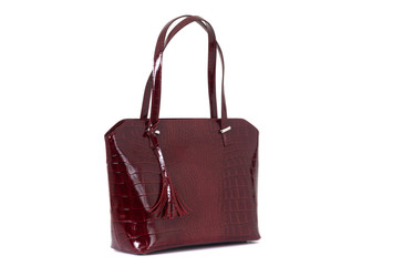 expensive red female leather bag on a handle isolated on a white background