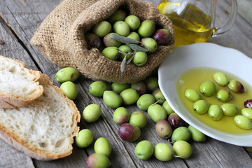 Olive sack, olive oil bottle and bread