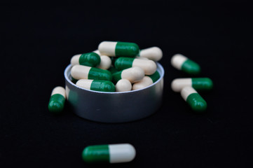close up a lot of pills and medicine isolated on black background 