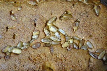 Bread crust covered with sunflower seeds, background