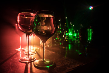 Goblet of white wine on wooden table on wooden wall background