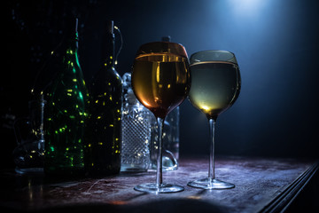 Goblet of white wine on wooden table on wooden wall background