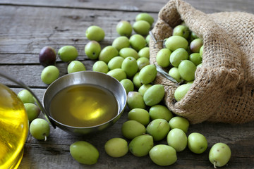 olive sack and olive oil bowl on wooden background