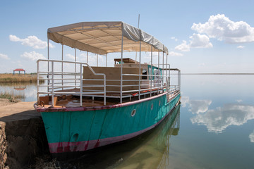 Touritic pleasure boat on Akhchakol Lake. Karakalpakstan, Uzbekistan, Central Asia.