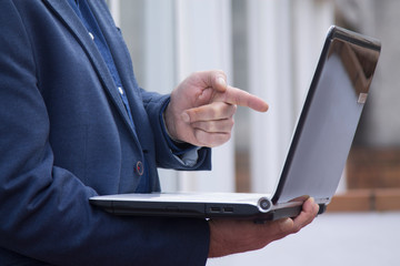 man pointing at laptop view close up