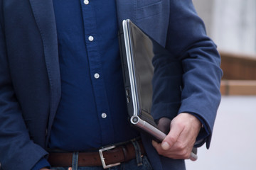 man with laptop under his arm