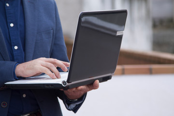 man typing on laptop