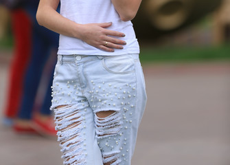 Obraz na płótnie Canvas slim legs and a beautiful body of a girl in jeans