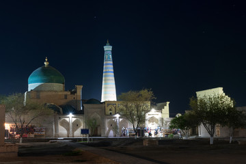 Fototapeta na wymiar Night view at Itchan Kala (old or inner town). Pahlavon Mahmud mausoleum and Islam Khoja Minaret. Khiva, Uzbekistan, Central Asia.