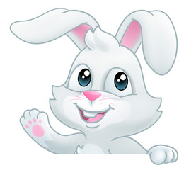 Obraz na płótnie Canvas Easter bunny rabbit cartoon character peeking over a sign background and waving
