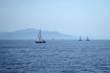 Fototapeta premium Blue sea navigation. Landscape with boats at horizon in a summer day.