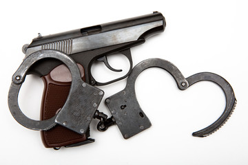 gun and handcuffs on a white background