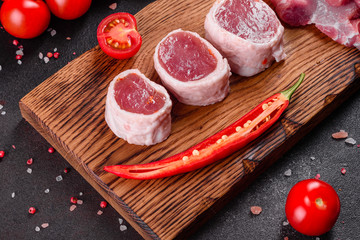 Fresh pieces pork ready to cook on a dark background in the kitchen