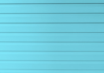 Blue construction vinyl siding panels. House covered with plastic vinyl siding. Vinyl siding wall surface with horizontal lines