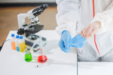 Fototapeta premium Medical scientists are wearing coronavirus protective clothing and rubber gloves before entering the lab for examination of coronavirus covid-19 and research for a vaccine against coronavirus covid19